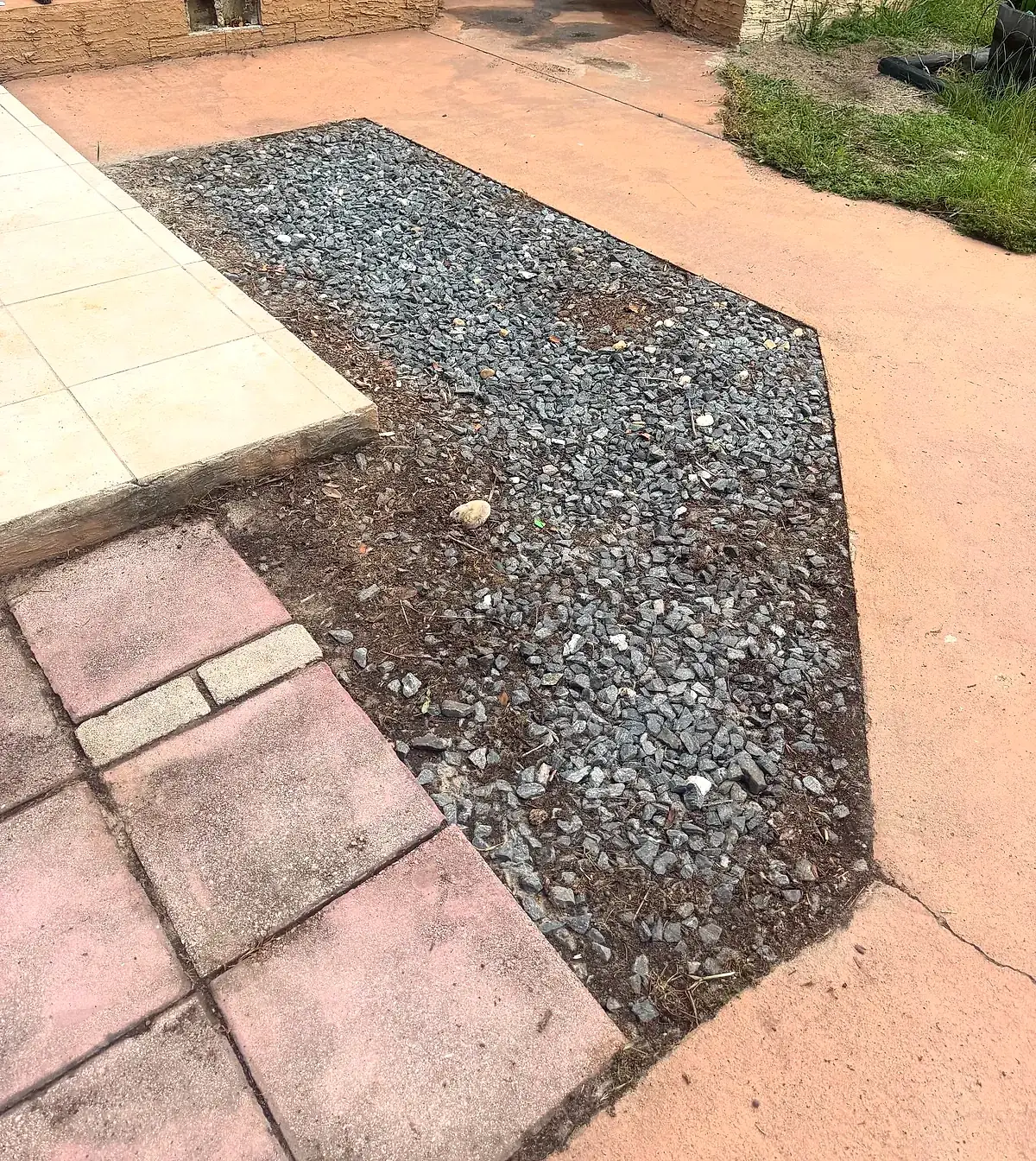 The same gravel bed cleared of weeds, edges clean