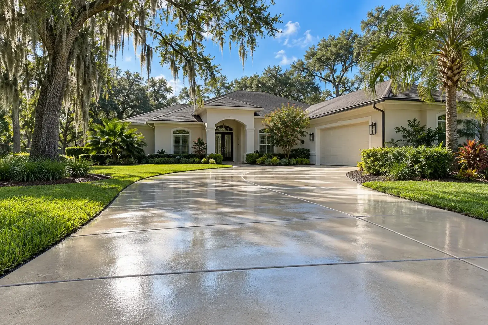 Freshly pressure-washed concrete driveway in front of a Florida home